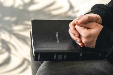 Close-up, holy Bible book in male hands.の写真素材