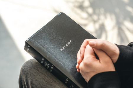 Close-up, holy Bible book in male hands.の写真素材