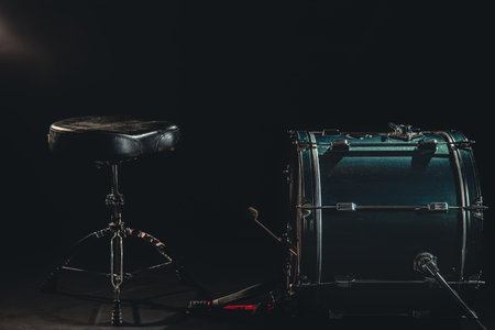 Bass drum and chair on a black background, drummers seat.の写真素材