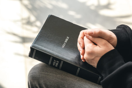 Close-up, holy Bible book in male hands.の写真素材
