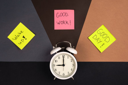 Alarm clock and stickers with motivational inscriptions, top view.の写真素材