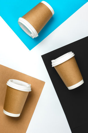 Paper cups on colored paper background, top view.の写真素材