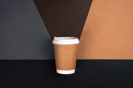 Disposable paper cup on brown paper background, top view.の写真素材