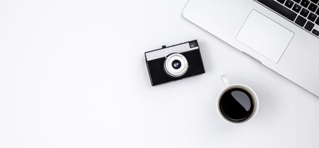 Laptop, coffee cup and retro camera on white background, top view.の写真素材