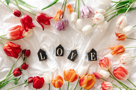 Spring background with flowers tulips and decorative word Love.の写真素材