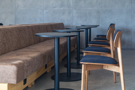 Interior of a modern cafe with sofas, chairs and tables.