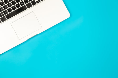 Laptop on a blue background, copy space.の写真素材