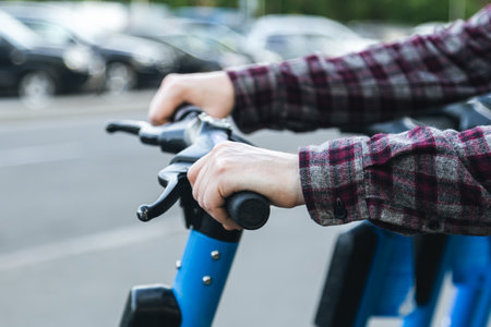 A man using a rental service with an e-scooter, close up.の写真素材