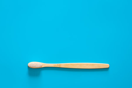 Natural eco-friendly bamboo brush on a blue background, copy space.の写真素材