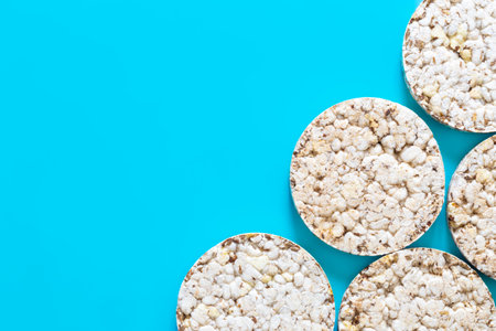Puffed rice cakes on blue background, flat lay, copy space.の写真素材