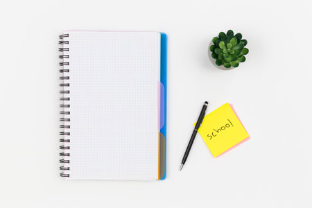 Notepad, glasses and pen on a white background, top view.の写真素材