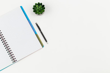 Notepad and pen on a white background, top view.