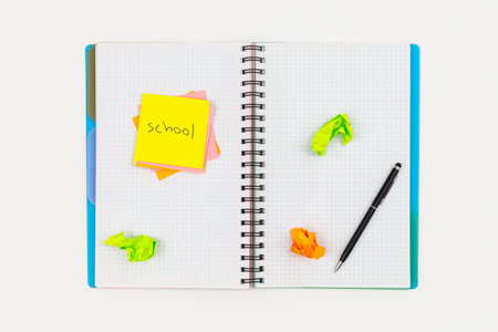 Notepad, pen and paper reminders on a white background.