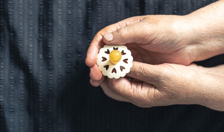 Close-up, a baby pacifier in the hands of a grandmother.の写真素材