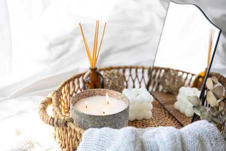 Spa composition with candles and aroma sticks in a wicker basket.の写真素材