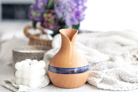 Spa composition with aroma oil diffuser lamp and candle on a blurred background.の写真素材