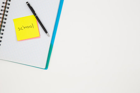 Notebook, pen and paper colored reminders on a white background.の写真素材