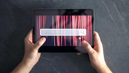 Digital tablet with internet browser search bar on screen in male hands.の写真素材