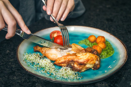 Chicken with vegetables on a plate in a cafe.の写真素材