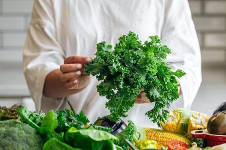 Parsley and kale close-up in the hands of a woman in the kitchen.の写真素材