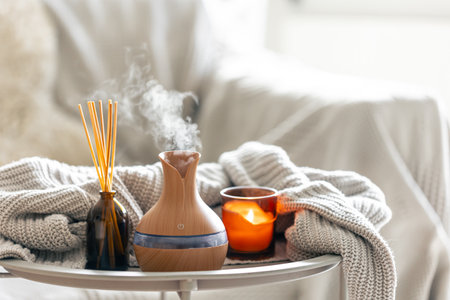 Aroma oil diffuser lamp with the stick perfume, knitted element and candle.の写真素材