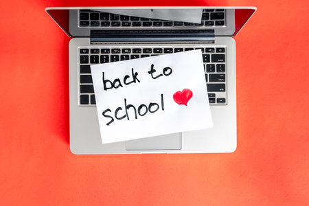 Laptop and a piece of paper with the inscription Back to school.の写真素材