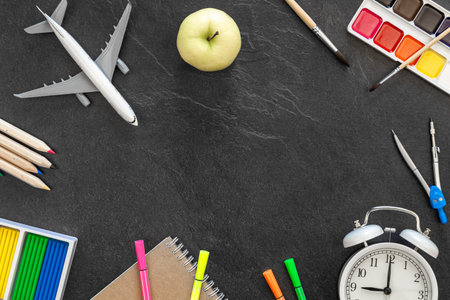 Flat lay school stationery on a black background, back to school concept.