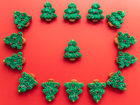 Christmas tree shaped gingerbread cookies covered with icing, flat lay.の写真素材