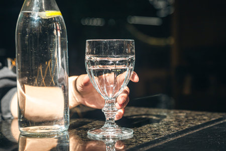 Drink water bottle with glass on table in the restaurant.