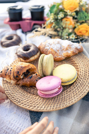 Macaroon croissants and donuts close up, picnic concept.