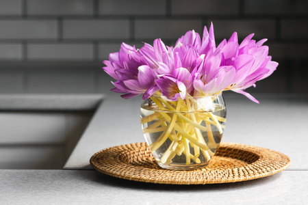 Bunch of crocus flowers in a glass vase in the kitchen.