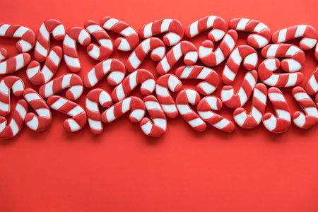 A lot of gingerbread candy cane shaped cookies, flat lay.