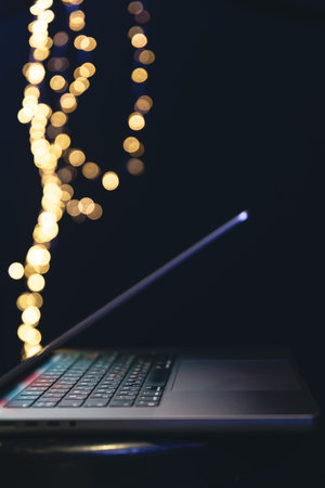 Close-up, laptop on a dark background with bokeh.の写真素材