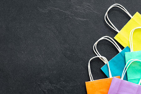 Paper shopping bags on a dark background, top view.の写真素材