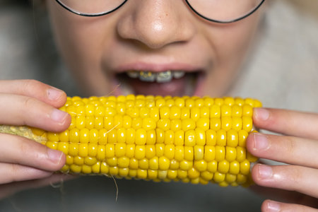 Detailed shot of a girl eating corn.の写真素材
