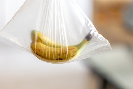 Ripe bananas in a plastic bag, close up.の写真素材
