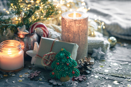 Cozy Christmas composition with a burning candle and decorative details.の写真素材