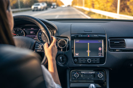 Woman driver hands on steering wheel inside car.の写真素材