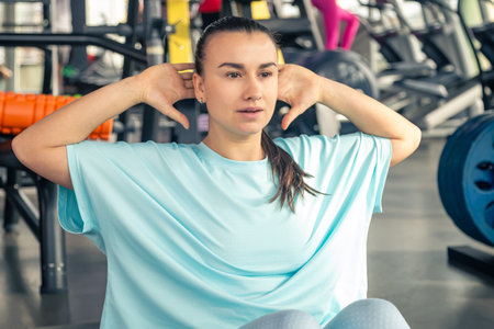 Sporty woman doing exercise on the floor in gym.の写真素材