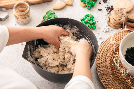 Preparation of homemade Christmas cookies, kneading dough in a bowl.の写真素材