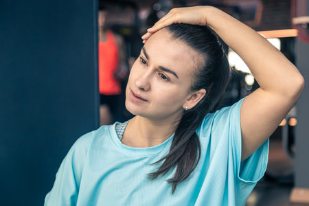 Portrait of fitness woman stretching at gym before workout.の写真素材