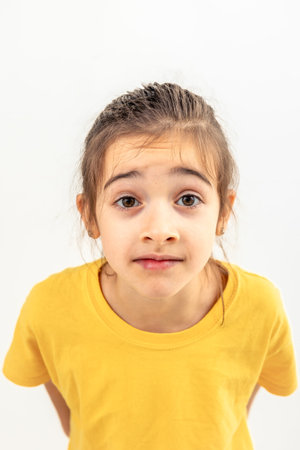 Little girl looking directly at the camera on a white background isolated.