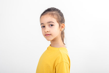 Portrait of girl in yellow t-shirt, isolated on white background.の写真素材
