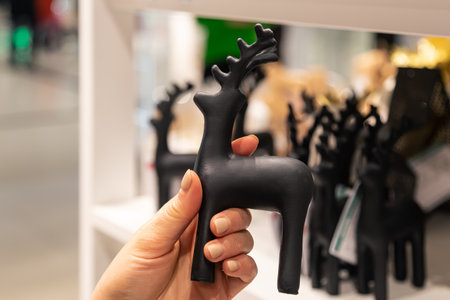 Decorative statue of a deer in female hands in a store.の写真素材