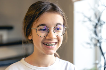 Portrait of a teenage girl with glasses and braces.の写真素材