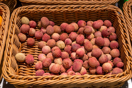 Lychees in a basket on a supermarket display.の写真素材