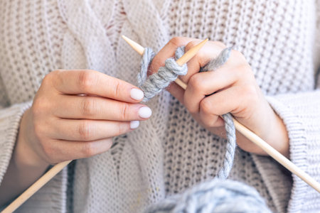 Close-up of hands knitting using circular needles.の写真素材