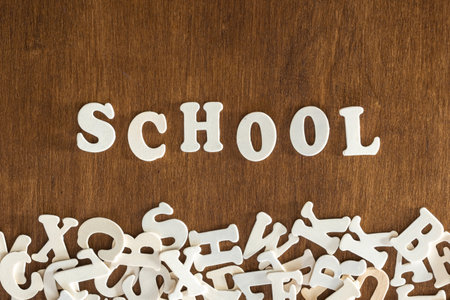 The word School made of wooden letters on a wooden background, top view.の写真素材