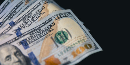 Close-up, American dollar bills on a black background.