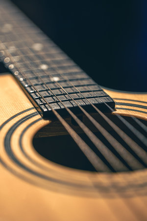 Close up of guitar and strings with shallow depth of field, soft focus.
